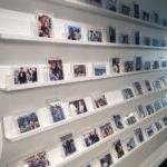 A wall with photos of important moments in the lives of employees